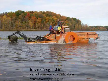 A large orange and yellow dredge in the water.