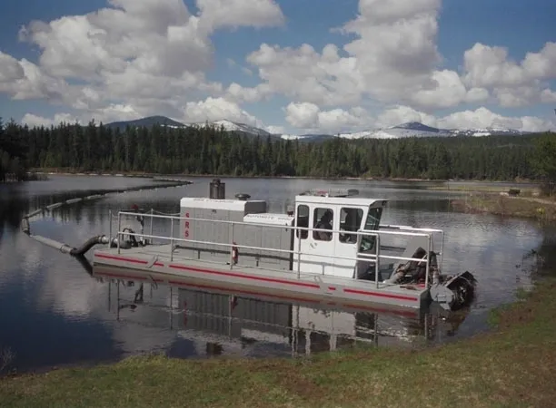 A boat is in the water near some trees.