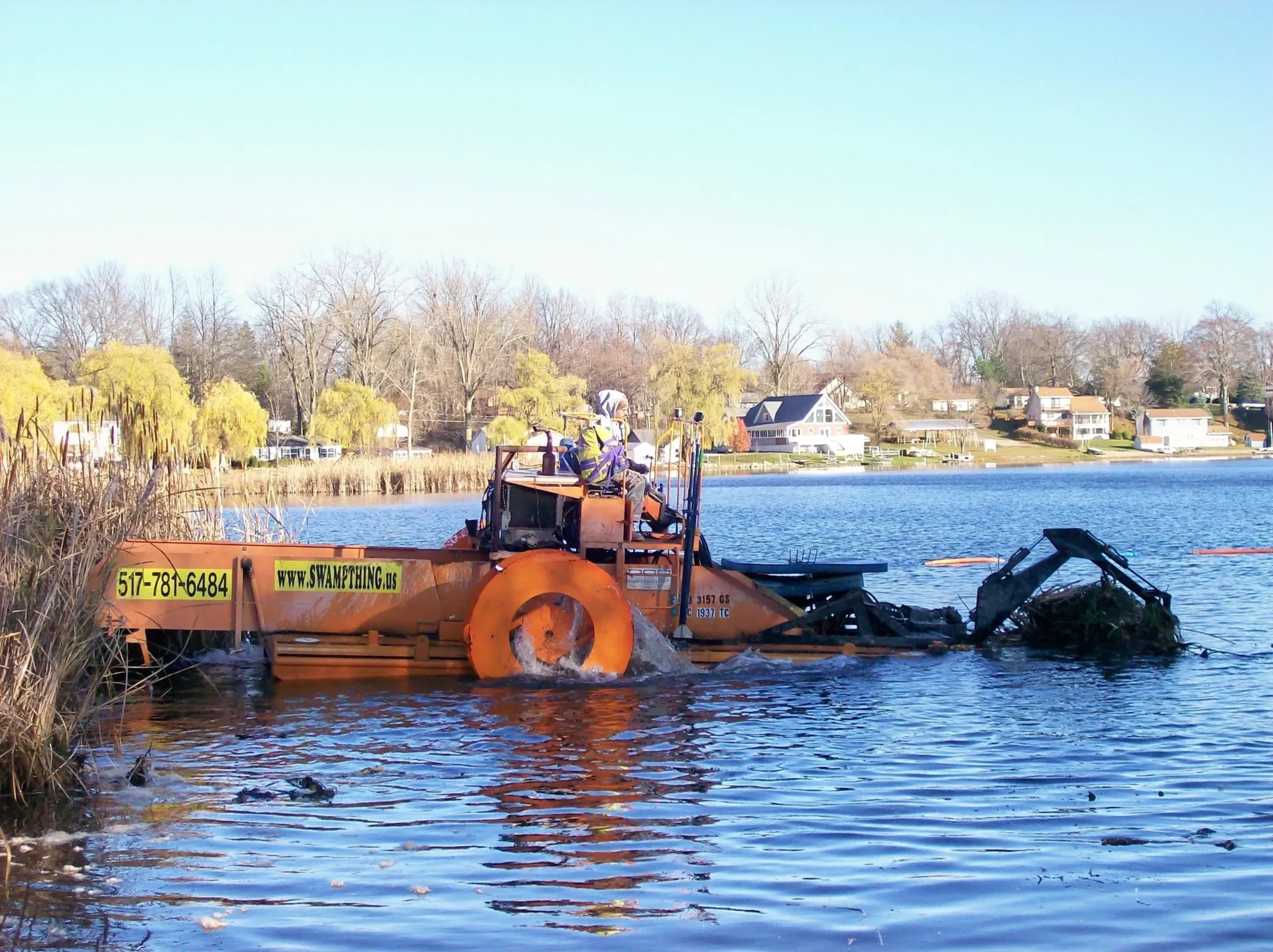 A boat is in the water with two people on it.