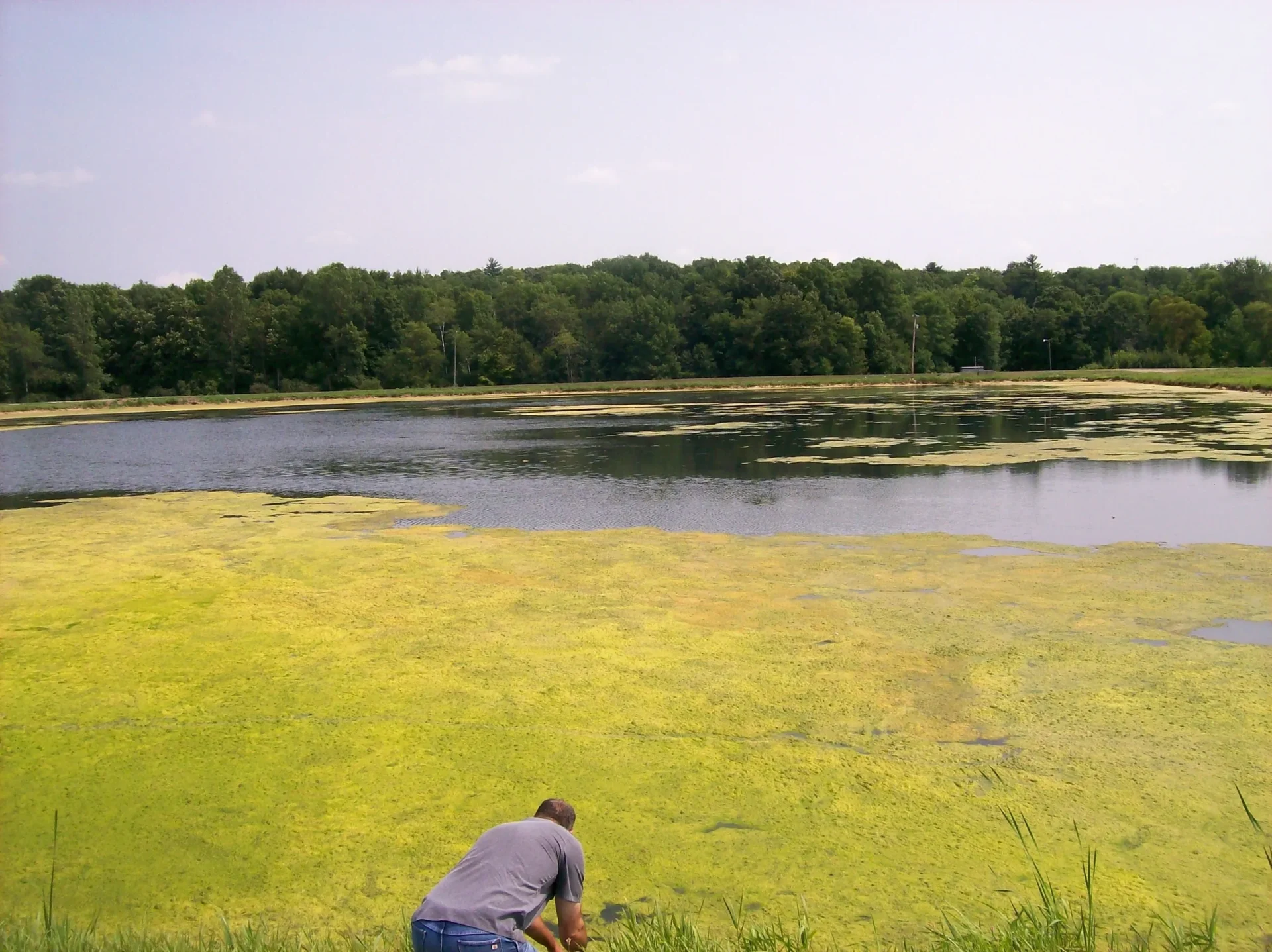 A man standing in front of a body of water.