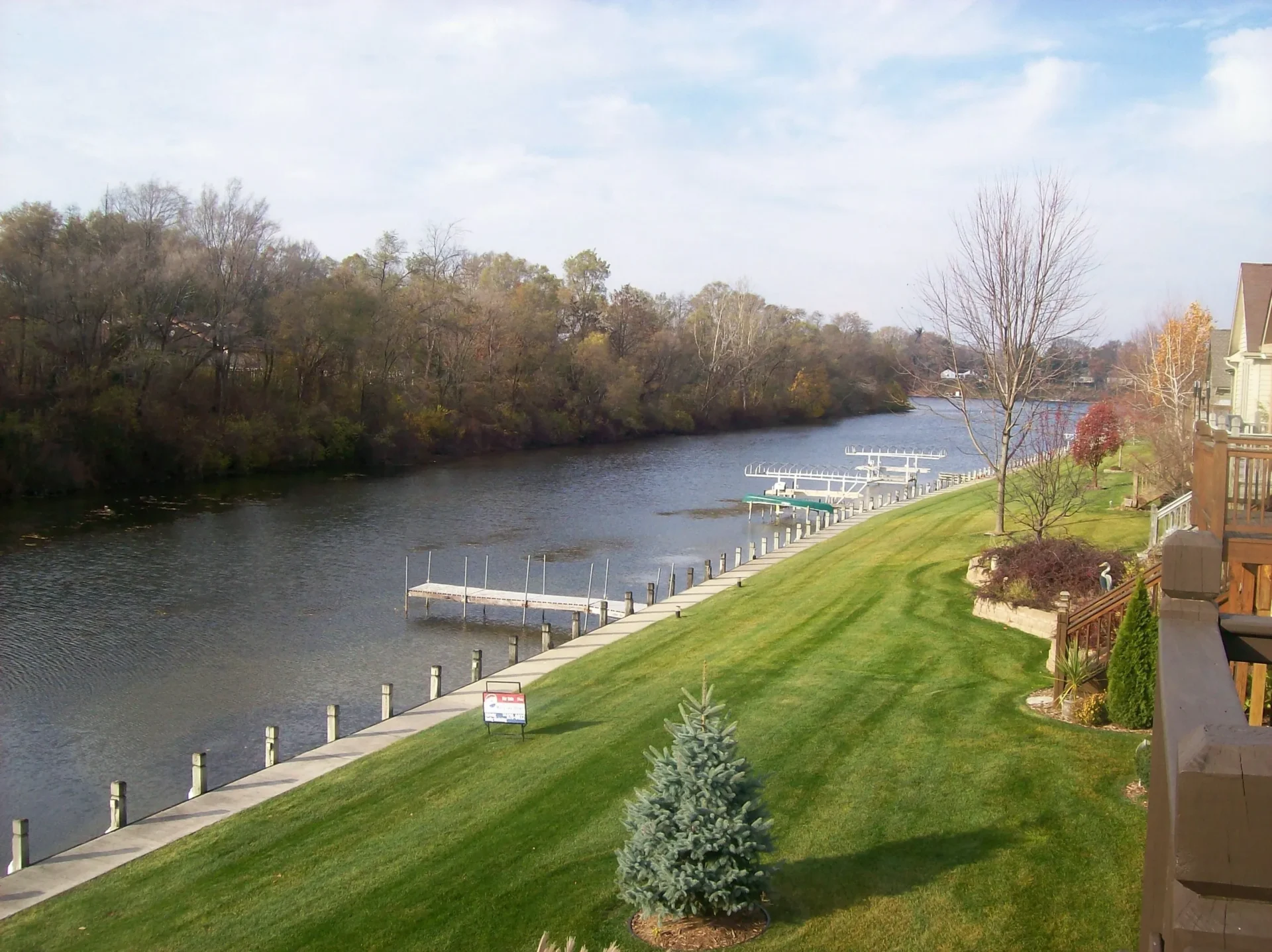 A river with a boat dock and trees in the background.