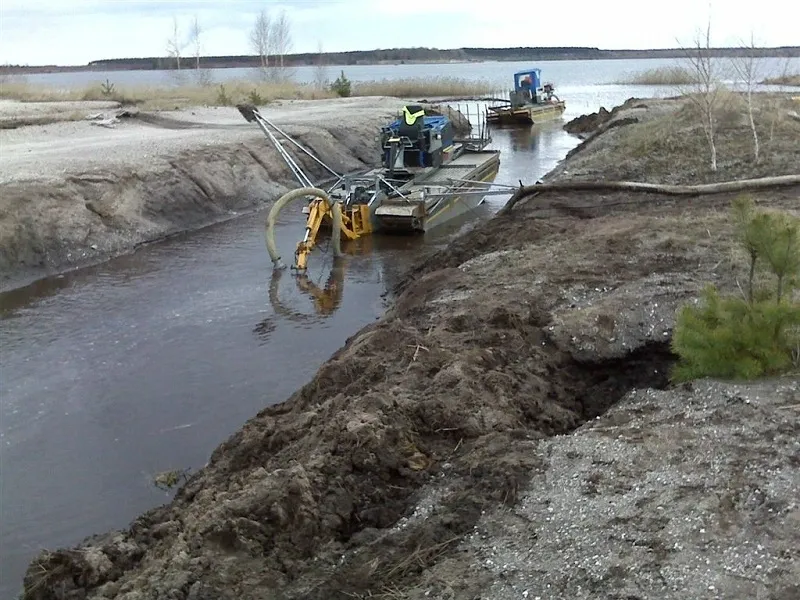 A boat is being used to move sand.