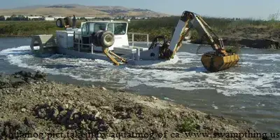 A large truck is pulling a boat out of the water.