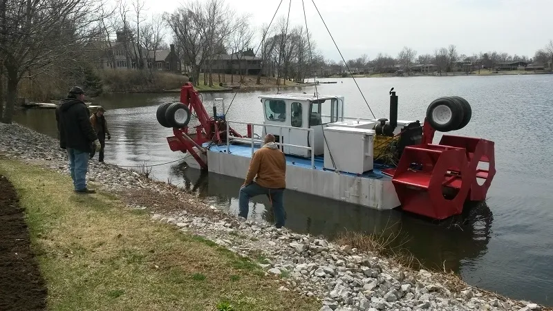 A man standing on the side of a boat.