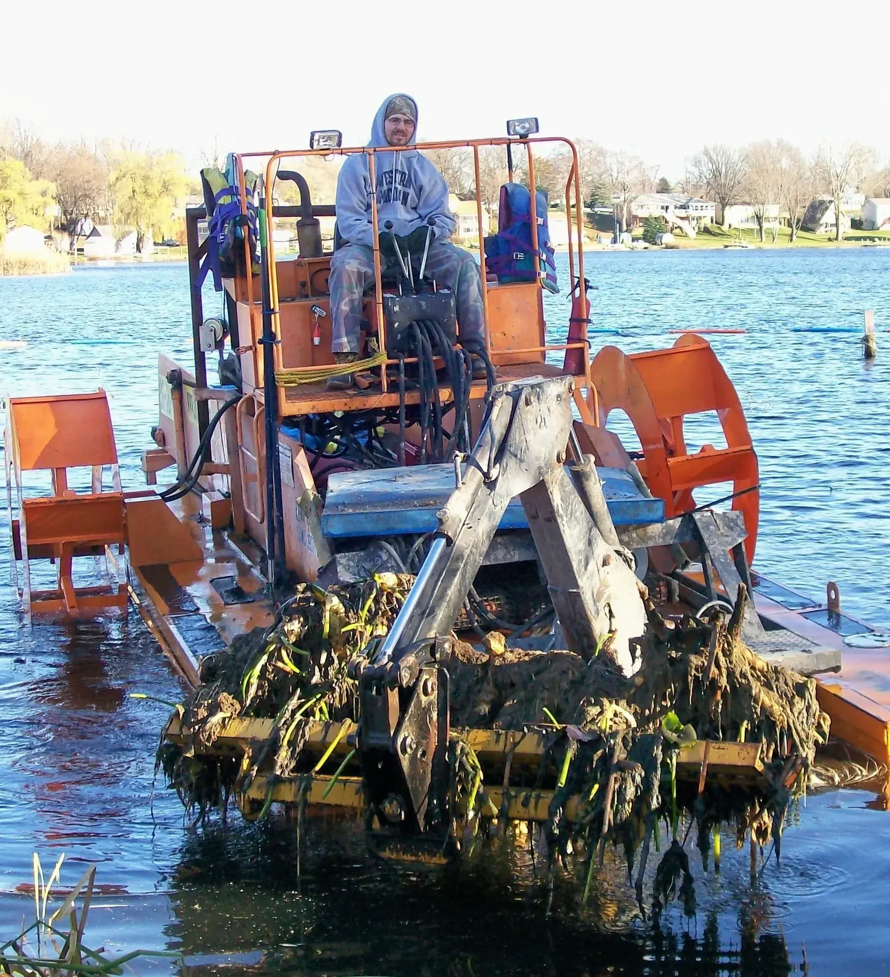 A man on an amphibious vehicle in the water.