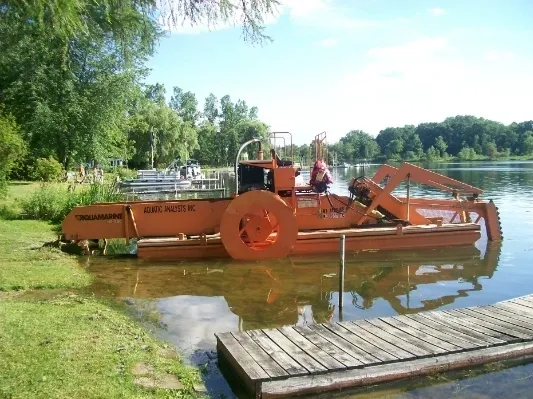 A boat is in the water near a dock.