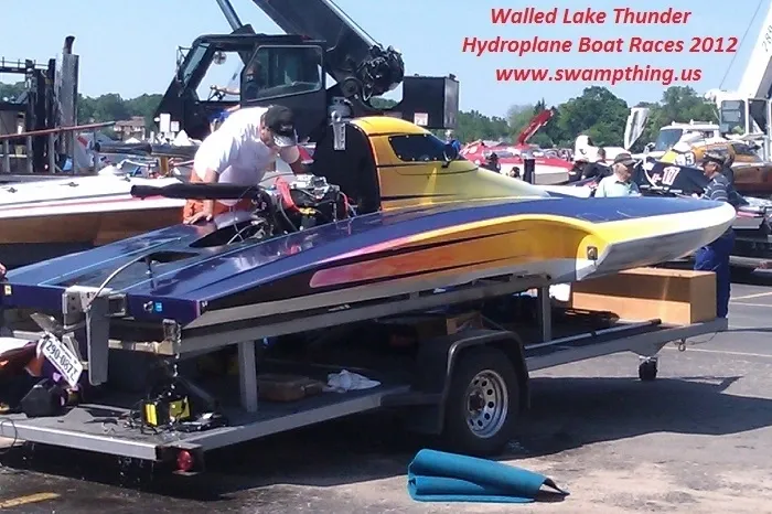 A boat is being loaded on the trailer.