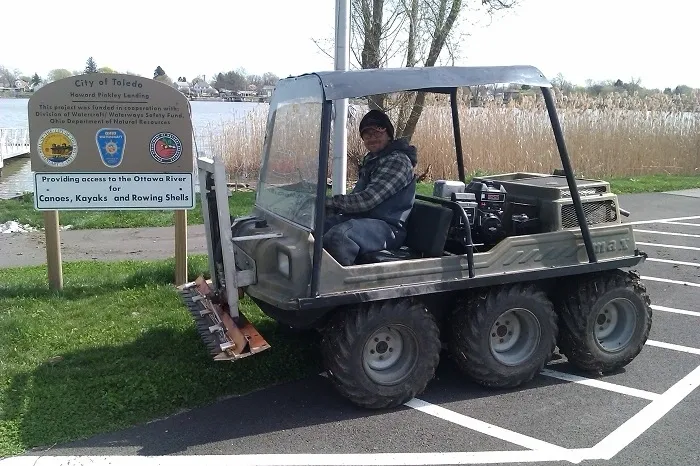 A man sitting in the back of an atv.