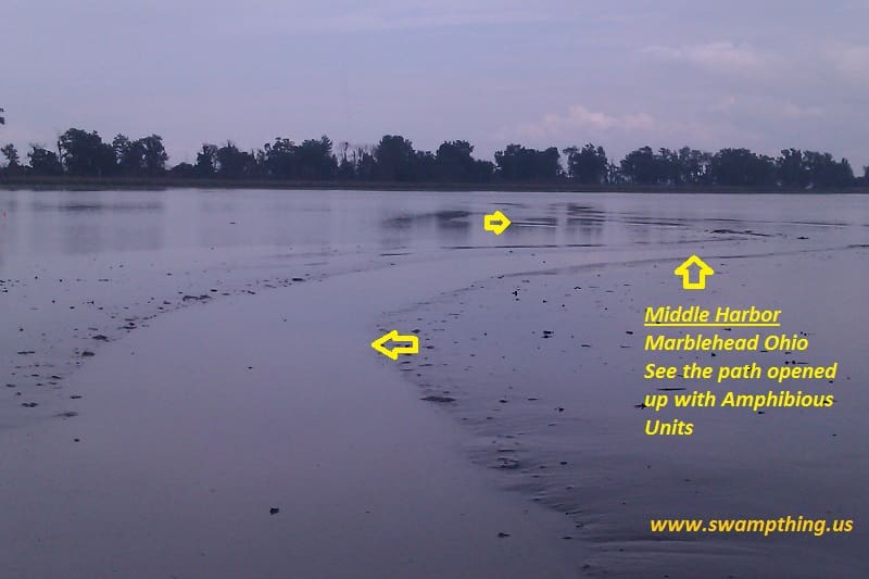 A body of water with yellow arrows pointing to the shore.