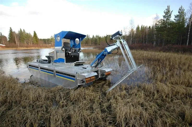 A boat is in the water and has been used to move grass.