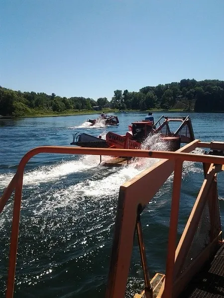 A boat is going down the river with two boats.