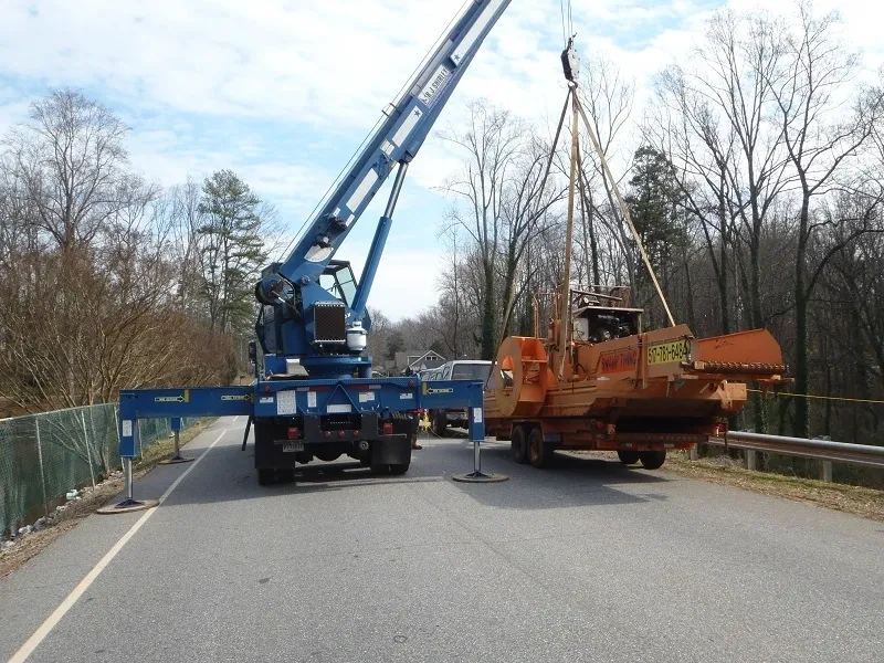 A crane is being used to lift a truck.