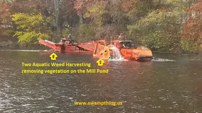 A large orange machine in the water.