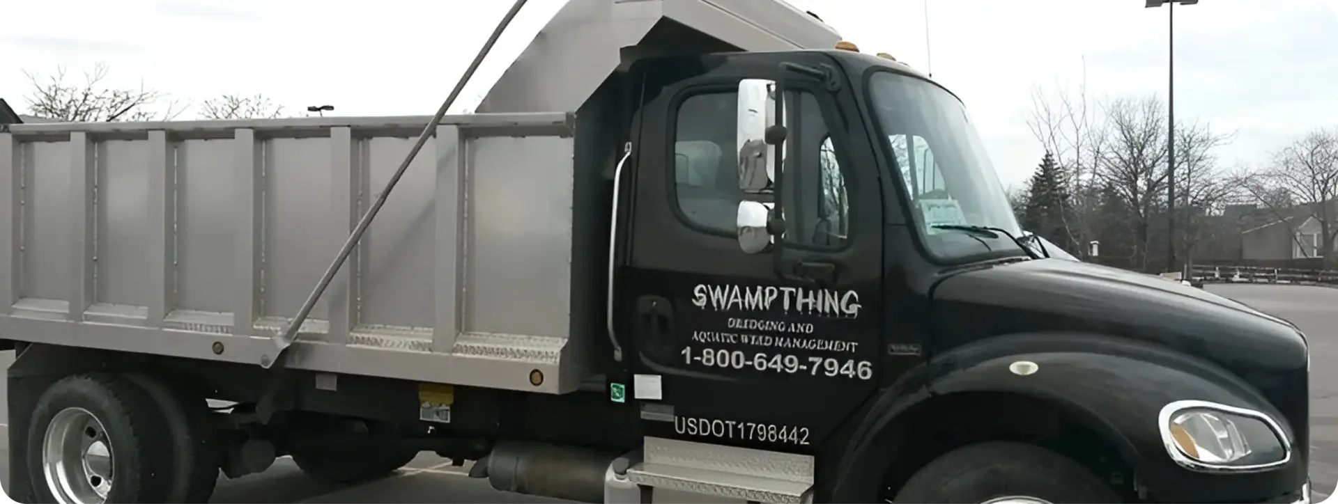 A dump truck with the words swamp thing on it.