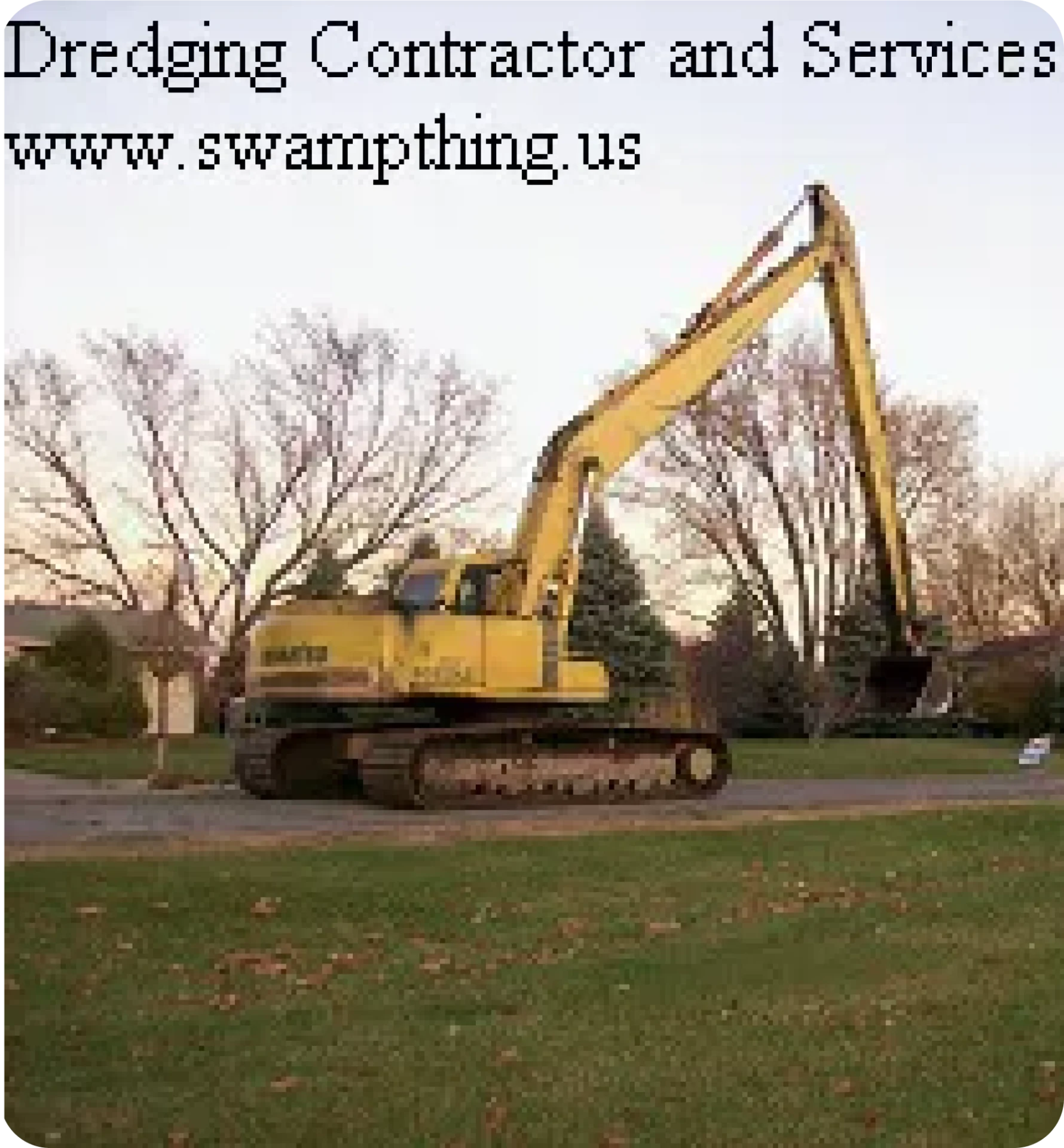 A yellow excavator is parked on the grass.